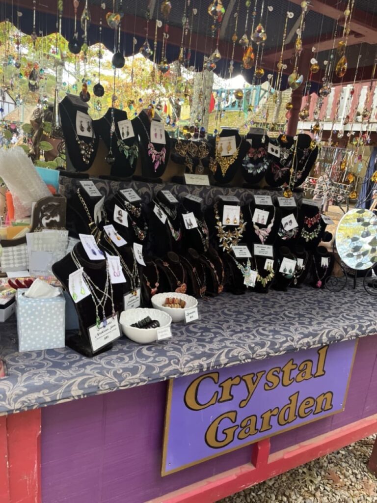 A shop at King Richard's fair called "the Crystal Garden," selling necklaces.