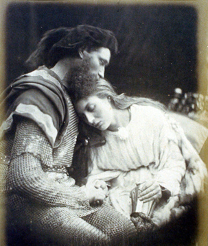 A Black and White albumen print of Lancelot and Guinevere. The two embrace each other with eyes closed. Both have a somber and peaceful look while holding hands. There is a tinge of sadness as they must part afterwards.